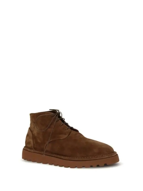 Premium brown leather men’s ankle boots with rugged sole, stylish laces, and durable construction for everyday wear and outdoor adventures.
