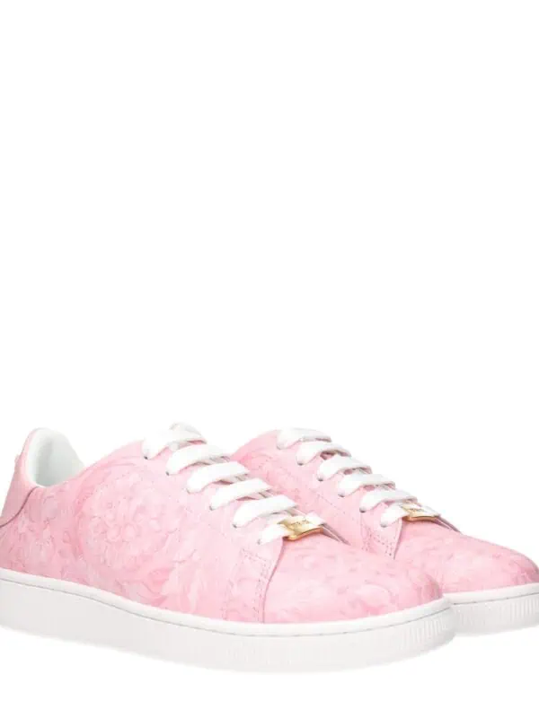 Pink floral pattern designer sneakers with white soles and laces, featuring gold-tone accents, perfect for stylish casual wear.
