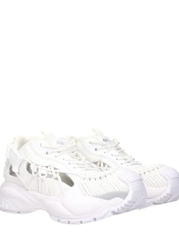 White designer sneakers with intricate cutout details for a modern luxury look.