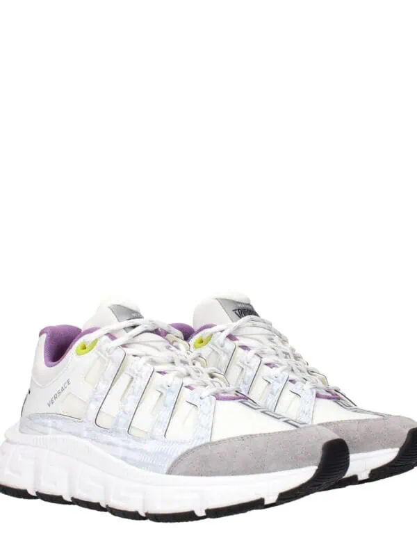 Stylish white and grey sneakers with purple accents from Versace, designed for comfort and luxury, featuring premium materials and distinctive branding details.