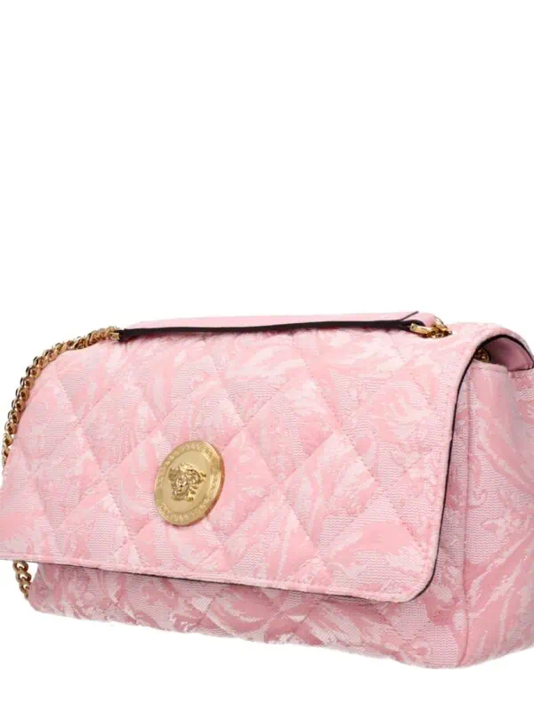 Luxurious pink designer handbag with gold chain strap and logo embellishment, featuring intricate jacquard fabric, perfect for upscale events and fashion-forward outfits.