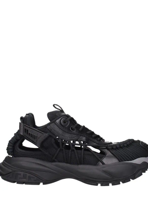 Black luxury designer sneaker featuring a futuristic design with mesh and leather accents, durable rubber sole, and intricate detailing, perfect for streetwear and high-end fashion enthusiasts.