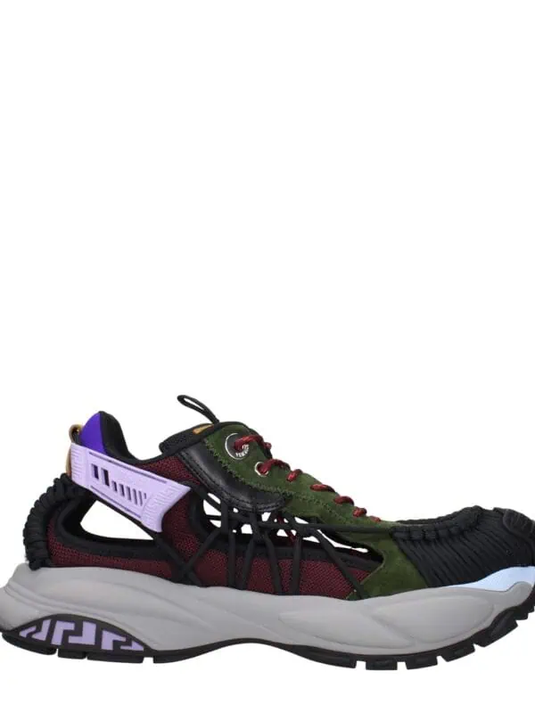 Luxury designer sneakers with a vibrant mix of black, green, purple, and red accents, featuring a chunky sole and modern, sporty silhouette.