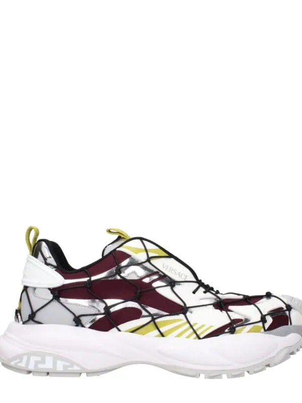 Versace chain-linked mesh sneaker with bold yellow, red, and white accents, featuring a chunky white sole and a distinctive high-tech design. Perfect for luxury streetwear or fashion-forward athletic wear.
