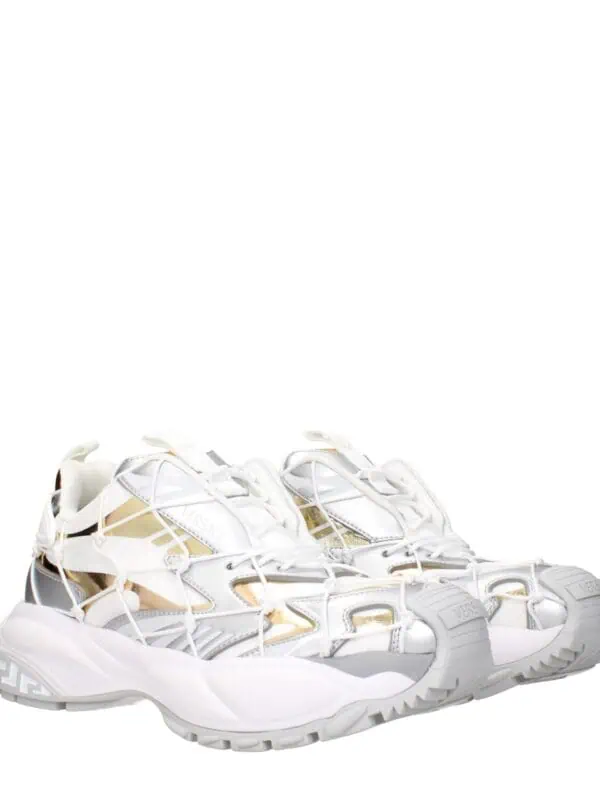 White designer sneakers with metallic accents and intricate design elements, showcasing luxury and fashion-forward style from Lux Brands.