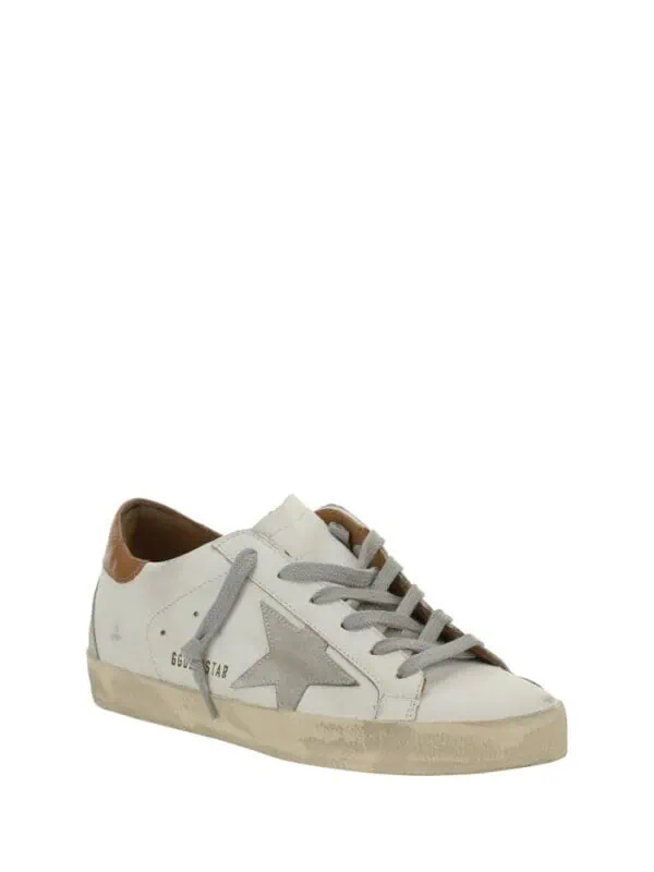 White leather fashion sneaker with grey star logo and tan accents, casual low-top design, stylish and versatile footwear by Golden Goose.