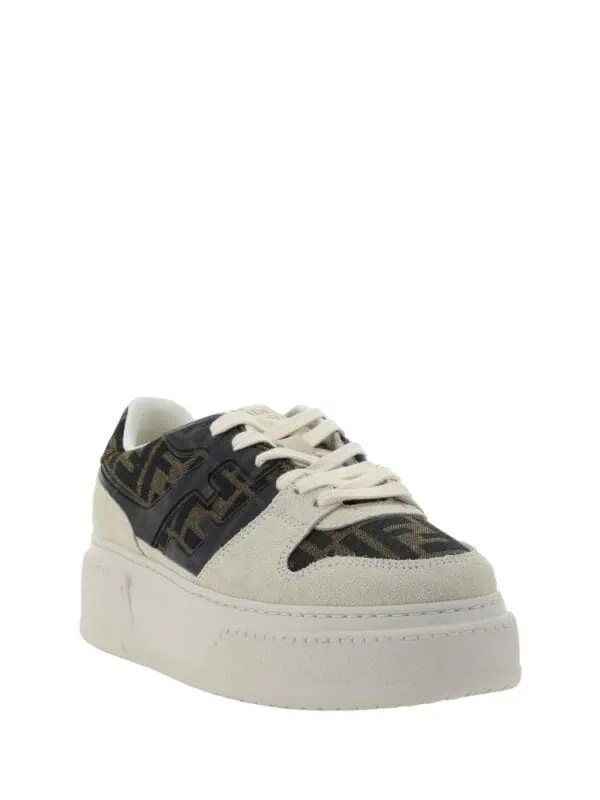 Lux Brands designer sneakers with monogram pattern, beige suede accents, and a chunky white sole for a stylish and luxurious look. Perfect for casual or chic outfits.