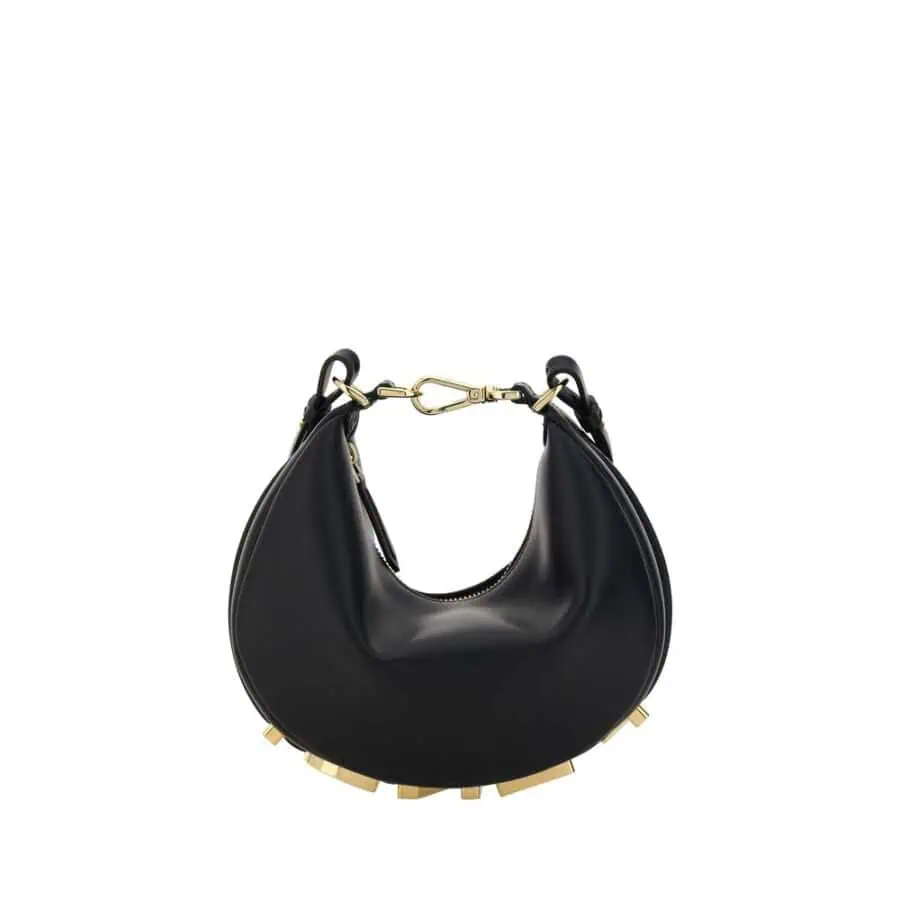 Luxurious black crescent-shaped handbag with gold-tone hardware, modern design, perfect for stylish occasions. Leather material with studded base adds a trendy touch to any outfit.