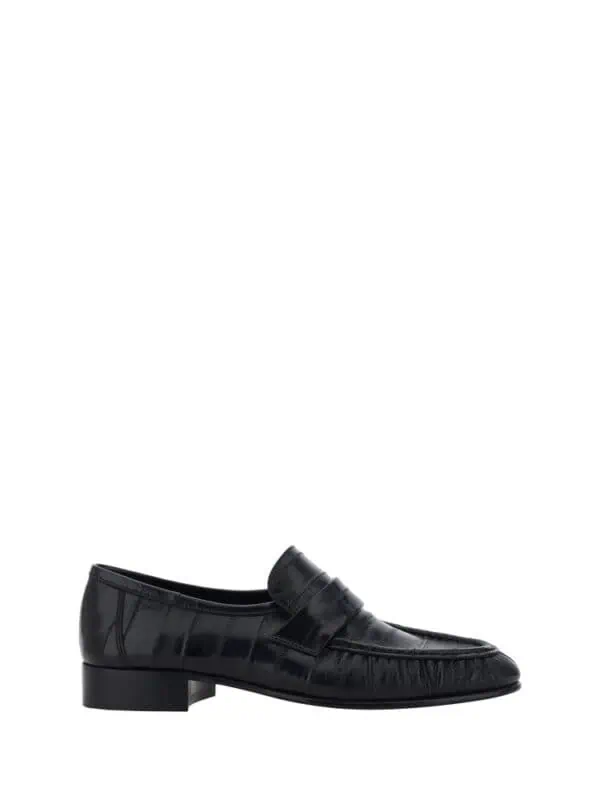 Stylish black leather loafer with a polished finish, perfect for formal and casual occasions. Comfortable slip-on design with a low heel for added elegance and ease of wear.