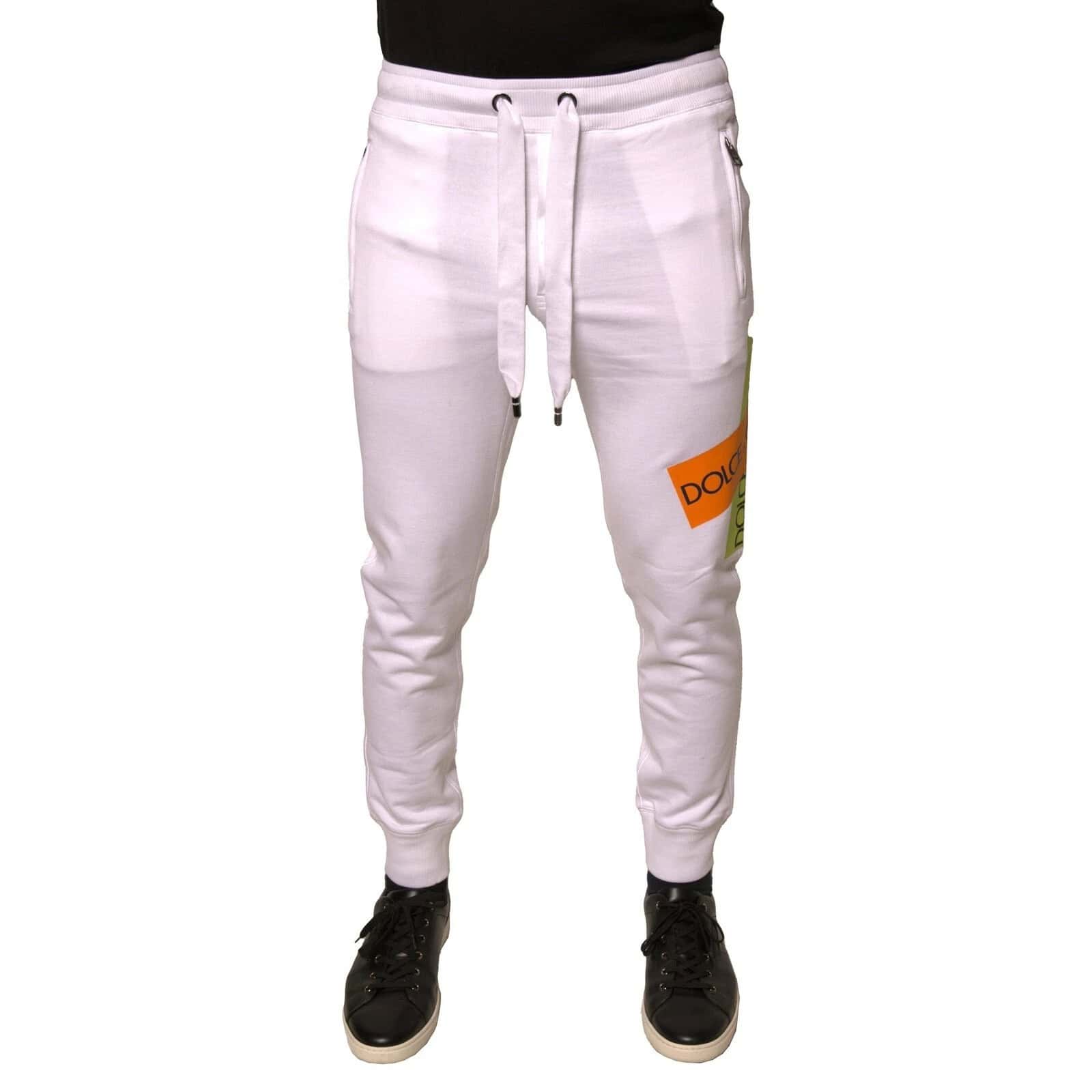 Dquad white sweatpants with colorful logo patch, drawstring waist, zippered pockets, and tapered ankle cuffs for a stylish, comfortable casual look.